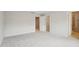 Empty bedroom with neutral carpet, showing the entrance to a walk-in closet and full bathroom at 272 Hiking Hill Ln, Garner, NC 27529