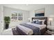 Staged bedroom featuring a bed, artwork, and natural light from the window at 272 Hiking Hill Ln, Garner, NC 27529