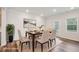 Dining room featuring hardwood floors, modern table and chairs, and natural light at 272 Hiking Hill Ln, Garner, NC 27529