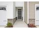 Inviting front entrance featuring stone accents, neutral colors, manicured landscaping, and house number at 272 Hiking Hill Ln, Garner, NC 27529