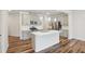 Modern kitchen with stainless steel appliances, white subway tile backsplash, and island with sink at 272 Hiking Hill Ln, Garner, NC 27529