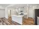 Modern kitchen features stainless steel appliances, gray cabinets, white subway tile backsplash, and island with sink at 272 Hiking Hill Ln, Garner, NC 27529