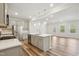 Modern kitchen featuring an island with seating, stainless steel appliances, and gray cabinets at 272 Hiking Hill Ln, Garner, NC 27529