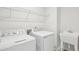 Laundry room featuring modern appliances, a utility sink, and overhead shelving at 272 Hiking Hill Ln, Garner, NC 27529