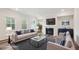 Staged living room features a large sofa, fireplace, stylish decor, and natural light at 272 Hiking Hill Ln, Garner, NC 27529