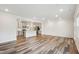 Spacious living room featuring wood floors, gray kitchen, bright lighting and modern design at 272 Hiking Hill Ln, Garner, NC 27529