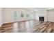 Bright living room featuring wood floors, a fireplace, and backyard access at 272 Hiking Hill Ln, Garner, NC 27529