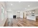 Bright, spacious living room features wood floors and a fireplace, seamlessly connected to the kitchen at 272 Hiking Hill Ln, Garner, NC 27529