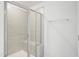 Modern shower with glass door and neutral tile, featuring a built-in bench at 272 Hiking Hill Ln, Garner, NC 27529