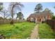 Spacious backyard with a wooden fence, established trees, and an inviting outdoor space at 2724 N Roxboro St, Durham, NC 27704