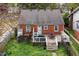 Aerial view of backyard with a deck, grill, mature trees, and a well-maintained lawn at 2724 N Roxboro St, Durham, NC 27704