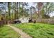 Backyard area featuring an outdoor shed and a grassy area, perfect for outdoor activities at 2724 N Roxboro St, Durham, NC 27704