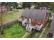 Overhead view of backyard with deck, grill, mature trees, and privacy fence at 2724 N Roxboro St, Durham, NC 27704