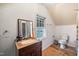 Cozy bathroom with a sink, vanity, and toilet against a white backdrop at 2724 N Roxboro St, Durham, NC 27704