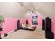 Bright pink bedroom with unique decor, sloped ceilings, and a bed on the floor at 2724 N Roxboro St, Durham, NC 27704