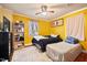 Cozy bedroom with twin beds, yellow walls, and natural light, offering a comfortable living space at 2724 N Roxboro St, Durham, NC 27704