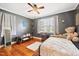 Stylish bedroom with hardwood floors, gray walls, natural light, and a cozy atmosphere at 2724 N Roxboro St, Durham, NC 27704