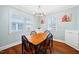 Well-lit dining room boasts hardwood floors, updated light fixture and lots of natural light at 2724 N Roxboro St, Durham, NC 27704