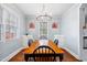 Bright dining room features hardwood floors, a chandelier, and natural light from the windows at 2724 N Roxboro St, Durham, NC 27704