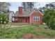 Charming red brick home with covered front porch and beautifully manicured lawn at 2724 N Roxboro St, Durham, NC 27704