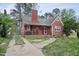 Charming red brick home with covered front porch and driveway at 2724 N Roxboro St, Durham, NC 27704
