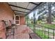 Covered front porch offering comfortable seating with vintage brick flooring at 2724 N Roxboro St, Durham, NC 27704