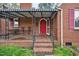 Inviting covered front porch with brick flooring and elegant railings at 2724 N Roxboro St, Durham, NC 27704