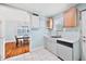 Kitchen with open view into dining room, updated counters, a stainless sink and a dishwasher at 2724 N Roxboro St, Durham, NC 27704
