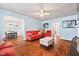 Cozy living room features hardwood floors, light blue walls, and ample seating with a ceiling fan and accent furniture at 2724 N Roxboro St, Durham, NC 27704