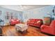 Cozy living room featuring hardwood floors, ample natural light, and comfortable seating at 2724 N Roxboro St, Durham, NC 27704