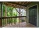 An exterior view of a balcony, complete with green sidings and a door that leads to an interior room at 308 Cedarwood Ln, Carrboro, NC 27510