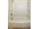 A clean and well-maintained bathtub and shower with built-in shelves at 308 Cedarwood Ln, Carrboro, NC 27510