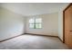 Bright bedroom with a large window and neutral carpet at 308 Cedarwood Ln, Carrboro, NC 27510