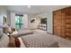 A bright bedroom features two beds, closet, and sliding glass doors to a balcony that provides an outdoor view at 308 Cedarwood Ln, Carrboro, NC 27510