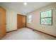 Bedroom with carpet, a closet, and two windows at 308 Cedarwood Ln, Carrboro, NC 27510