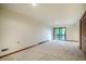 A bedroom features closet with brown wooden doors, sliding glass doors that leads to an outdoor balcony at 308 Cedarwood Ln, Carrboro, NC 27510