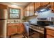 Efficient kitchen setup featuring stainless steel appliances and wood cabinets at 308 Cedarwood Ln, Carrboro, NC 27510