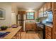 Cozy kitchen nook with wooden table, stainless fridge and a view of trees at 308 Cedarwood Ln, Carrboro, NC 27510
