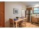 Kitchen nook with wood table, stainless steel fridge and a bright window at 308 Cedarwood Ln, Carrboro, NC 27510