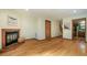 Spacious living room featuring hardwood floors, a fireplace, and access to the kitchen at 308 Cedarwood Ln, Carrboro, NC 27510