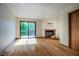 Bright living room featuring hardwood floors, fireplace, and sliding glass door to deck at 308 Cedarwood Ln, Carrboro, NC 27510