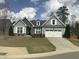 Charming single Gathering home featuring stone accents, a two-car garage, and meticulously manicured landscaping at 338 Apalachia Lake Dr, Fuquay Varina, NC 27526
