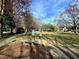 Relaxing community area with mature trees, brick walkway, stone bench and community bookshelves at 3421 E E Jameson Rd, Raleigh, NC 27604