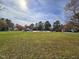 Community pool with large green space, trees and clear blue sky, perfect for community gatherings and relaxation at 3421 E E Jameson Rd, Raleigh, NC 27604