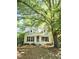 Charming home with dormer windows, black shutters, white trim and siding, and covered front entry at 3421 E E Jameson Rd, Raleigh, NC 27604