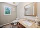 Bathroom featuring granite countertops, warm wood cabinetry, and stylish fixtures at 3421 E Jameson Rd, Raleigh, NC 27604