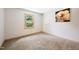 Bedroom with a window overlooking lush greenery and neutral decor at 3421 E Jameson Rd, Raleigh, NC 27604