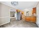 Open kitchen layout with stainless steel appliances, wood cabinets, and adjacent breakfast nook at 3421 E Jameson Rd, Raleigh, NC 27604