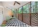 Screened porch with outdoor seating overlooking backyard trees for shaded relaxation at 3421 E Jameson Rd, Raleigh, NC 27604
