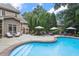 Luxurious backyard pool surrounded by lush landscaping and lounge chairs at 3530 Thorndike Dr, Wake Forest, NC 27587